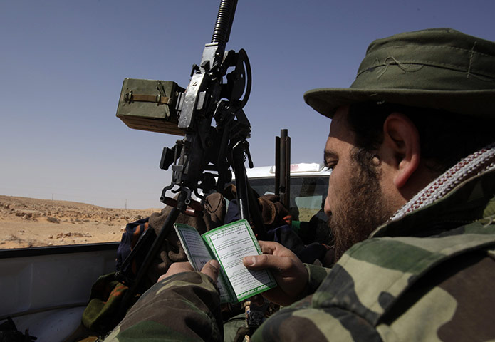 Libya Uprising: Anti-Gaddafi rebel reads Islamic prayers Ras Lanuf