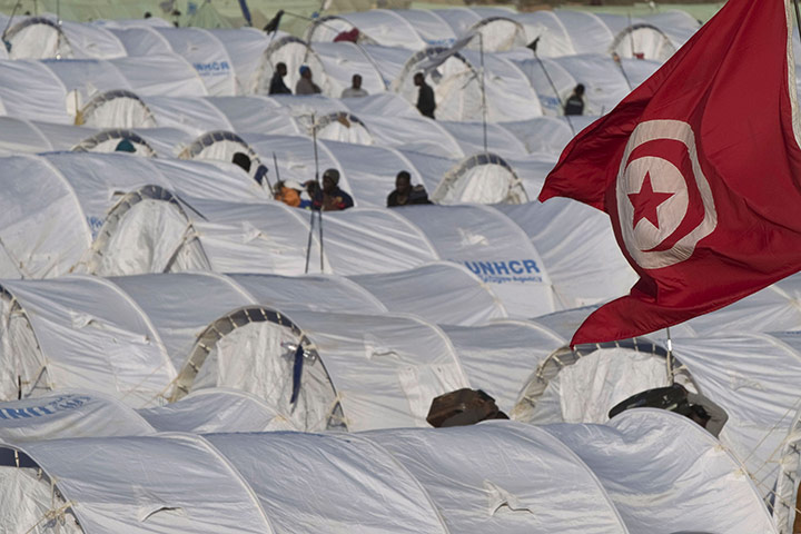 Ras Jdir Refugees: A Tunisian flag flies above tents in the Choucha refugee camp
