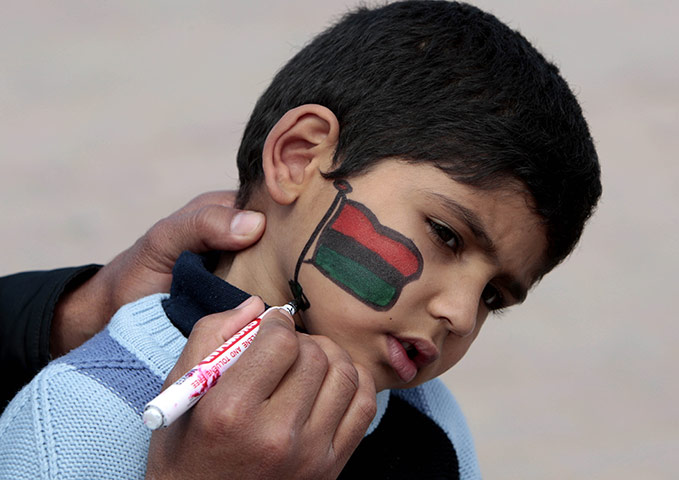 Benghazi Protests: A protester paints a Libyan flag on his sons face