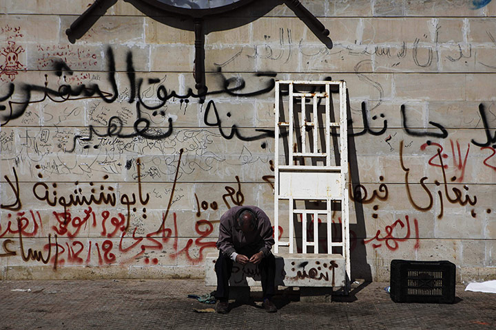Benghazi Protests: An anti-Gaddafi protester prays in Benghazi
