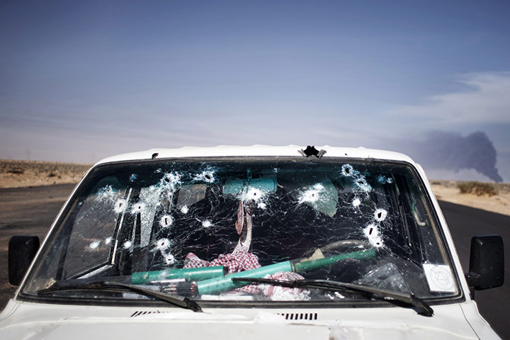 Libya unrest: an abandoned bullet-ridden car