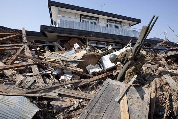 Dan Chung in Japan: A rescue worker picks through the ruins in Shintona, Japan