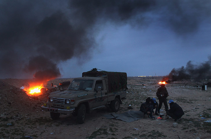 24 hours in pictures: opposition rebels battle gaddafi forces in eastern libya