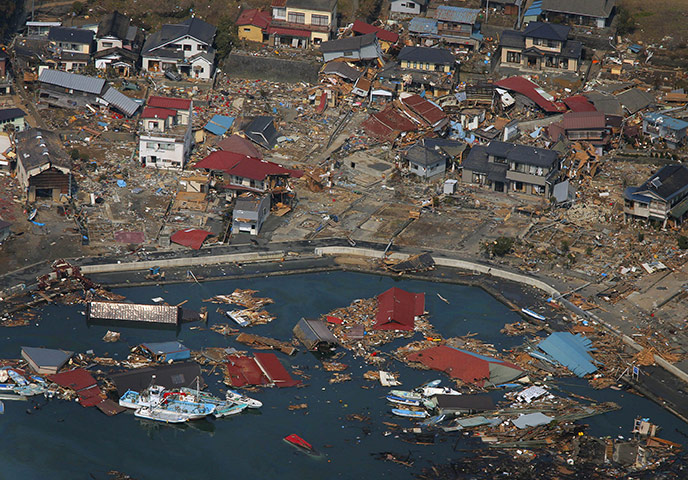 japan quake aftermath: Wrecked ships, houses and debris float in the sea in Kesennuma 