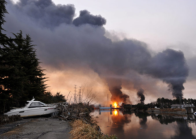 japan quake aftermath: Blaze and smokes rise from a petroleum refining plant