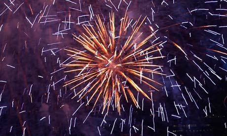 Fireworks explode beside the London Eye 