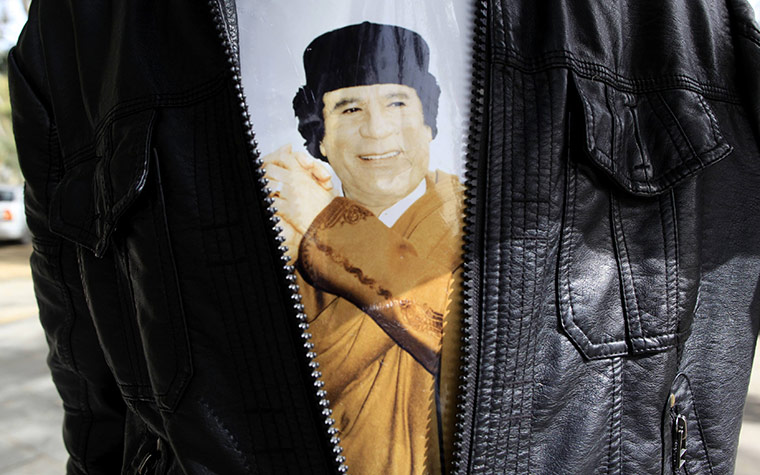 24 hours in pictures: boy with picture of Gaddafi under his jacket in Tripoli