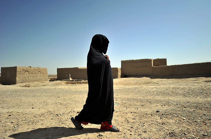 24 hours in pictures: A local woman returns home after meeting with US Marines in afghanistan