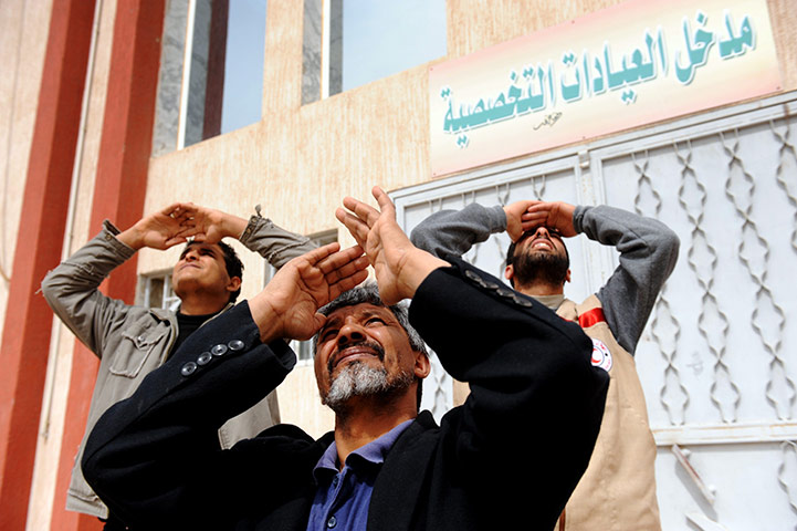 24 hours in pictures: Libyan men look at a reconnaissance plane in Ajdabiya 