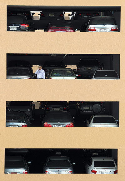 24 hours in pictures:  Thai office worker talks on his mobile phone