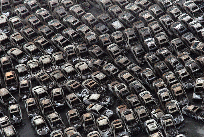 24 hours in pictures: Cars burnt out by fires triggered by the tsunami in Japan