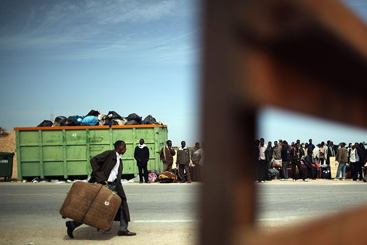 24 hours in pictures: Refugees Cross Tunisian Border To Escape Violence in Libya