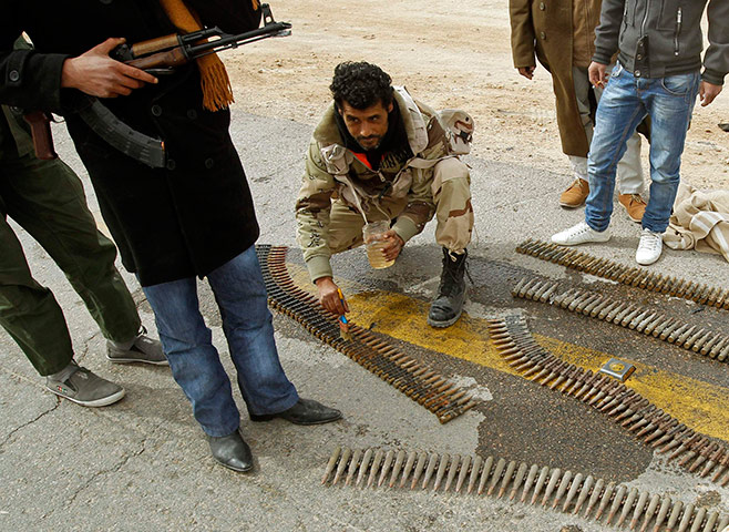 Libya, Ajdabiya: A rebel fighter cleans the ammunition rounds in Ajdabiya