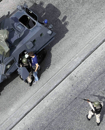 Bahrain uprising: Bahraini National guard arrest a man believed to be a journalist