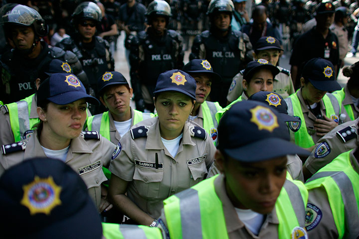 24 hours in pictures: National Bolivarian policewomen stand guard in Caracas, Venezuela