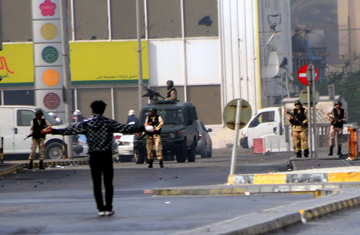 Bahrain uprising: A protester stands in front of the military in Pearl Square 