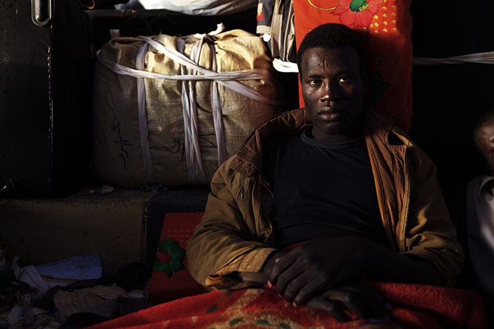 24 hours: Libya: A Chadian refugee sits at the Libya-Egypt border