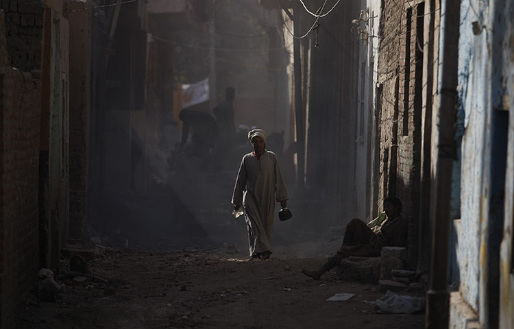 24 hours: Soul, Egypt: An Egyptian man passes in front of workers 