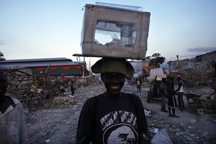 24 hours: Port-au-Prince, Haiti: A man displays cookies for sale in a ballot box