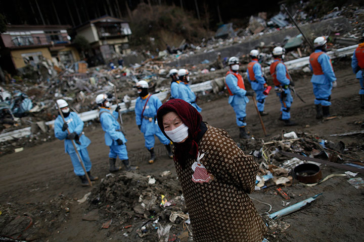 Japan aftermath: A woman walks through a residential area in Rikuzentakata