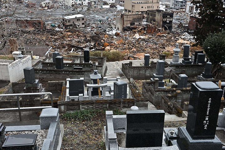 Japan aftermath: The devasted town of Otsuchi in Iwate prefecture behind tombstones