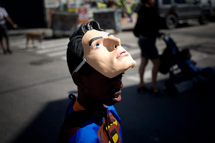 24 hours in pictures: Tel Aviv, Israel: An African boy dressed as Superman takes part in the Purim parade