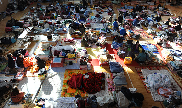 Japan Earthquake: Displaced people rest in the main hall of a primary school in Minamisanriku