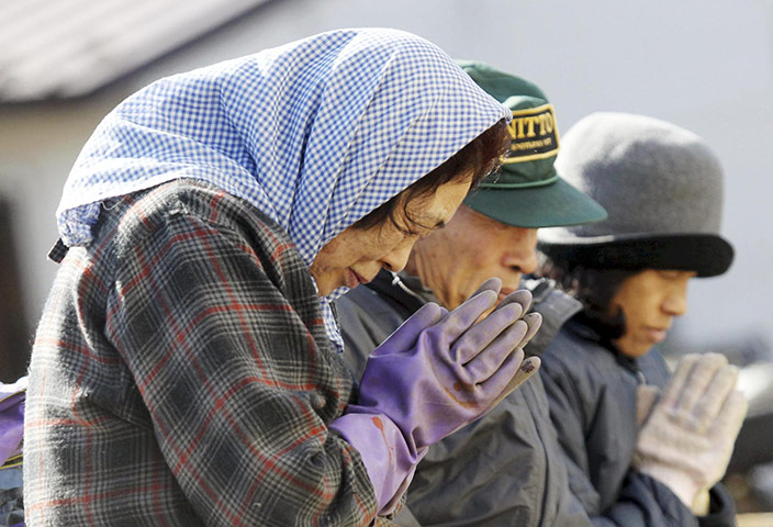 Japan Earthquake: Survivors pray for victims at the devastated city of Miyako northeast Japan