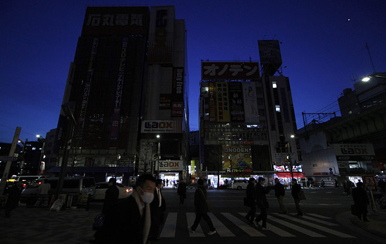 Japan Earthquake: Neon signs on electronics shops are tuned off to save energy in Tokyo