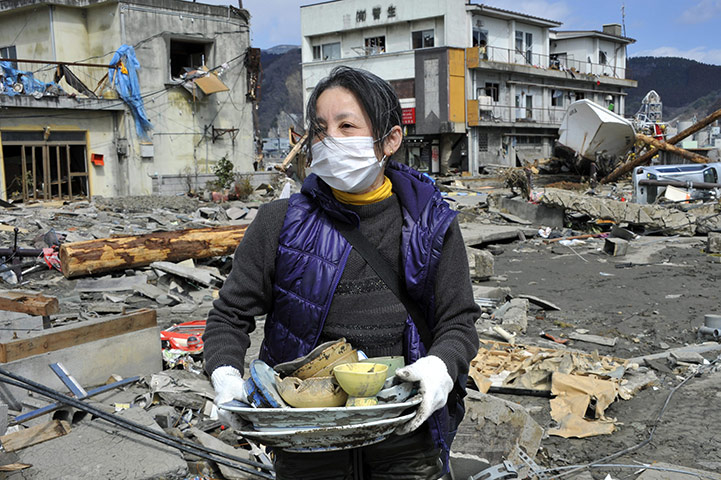 Japan Earthquake: Tsunami survivor digs out belongings