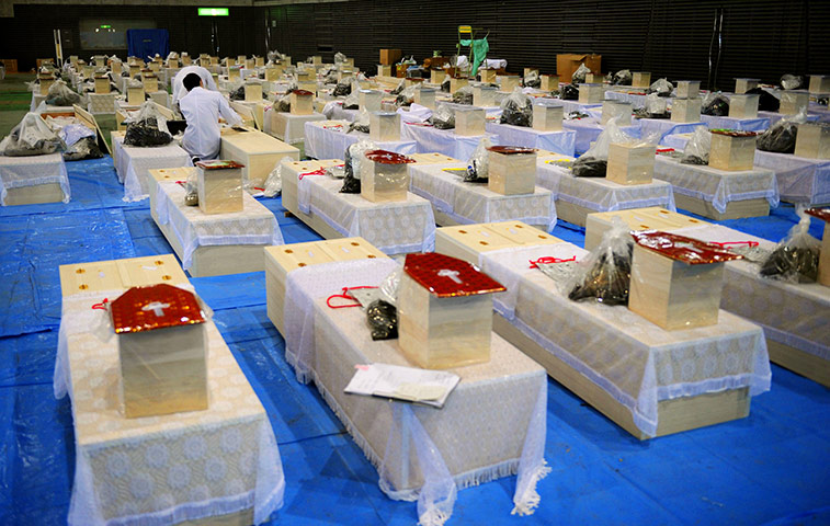 Japan Earthquake: Officials examine one of the bodies of victims in Rifucho Miyagi Prefecture