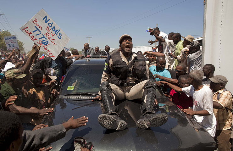 24 Hours In Pictures: Police Officer in Haiti