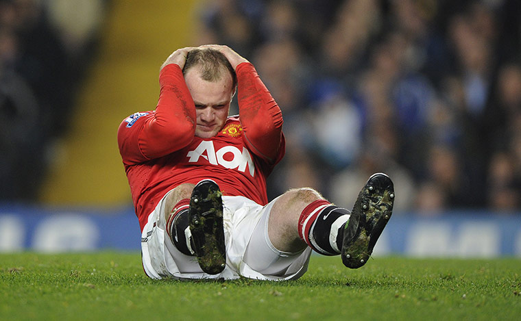 Chelsea v Man Utd: Wayne Rooney feels the pain after a challenge by David Luiz