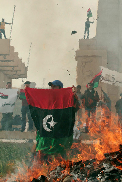 Libya: Protesters burn pictures of Libyan leader Muammar Gaddafi 