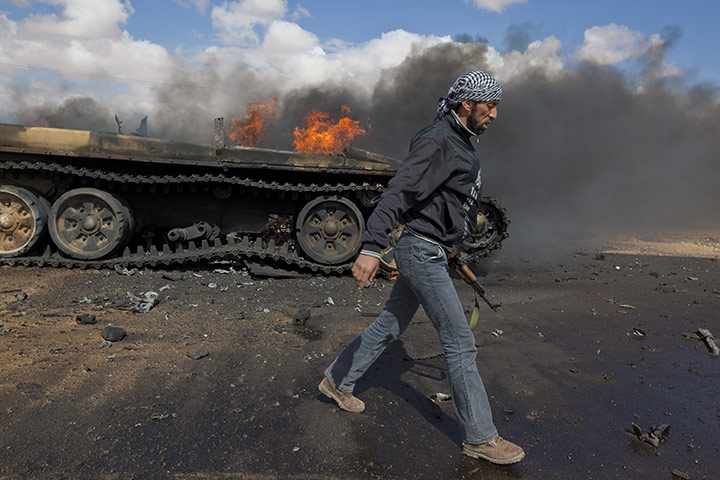 Sean Smith in Libya: 20 March: A rebel soldier walks past destroyed tank 