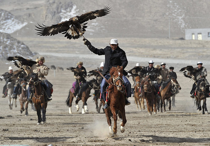 Spring festivals: Herdsmen from the Kyrgyz ethnic group hold falcons to celebrate Nowruz