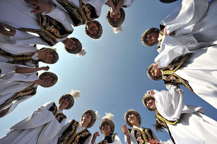 Spring festivals: Traditionally dressed Kyrgyz dance in the centre of Bishkek, Kyrgyzstan 