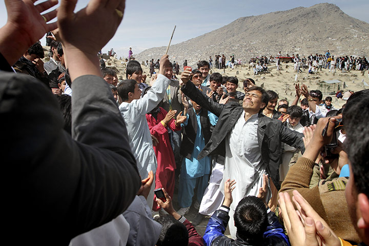 Spring festivals: Afghans dance outside the Sakhi Shrine on Nowruz, in Kabul, Afghanistan