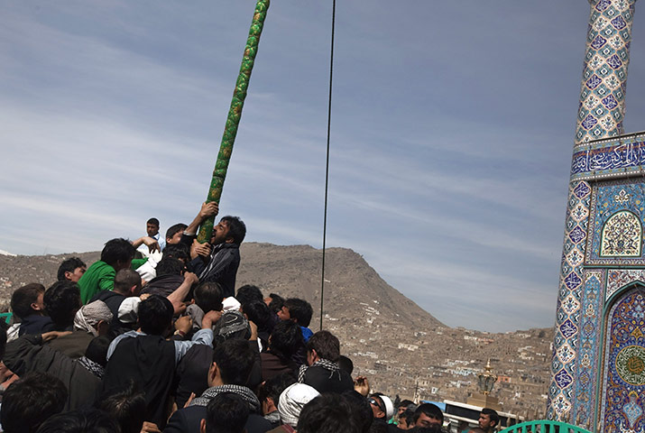 Spring festivals: Afghans try to kiss a religious flag to celebrate Nowruz in Kabul 