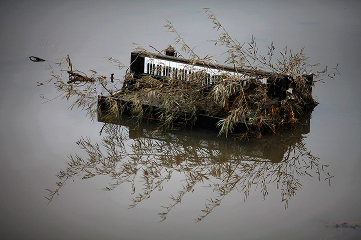 Japan aftermath continues: A piano is submerged in water in Rikuzentakata, Japan