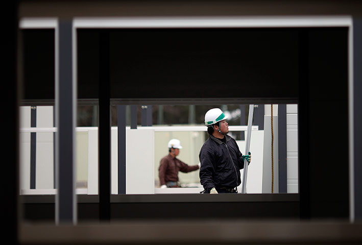 Japan aftermath continues: Japanese workers build shelters for people evacuated in Rikuzentakata