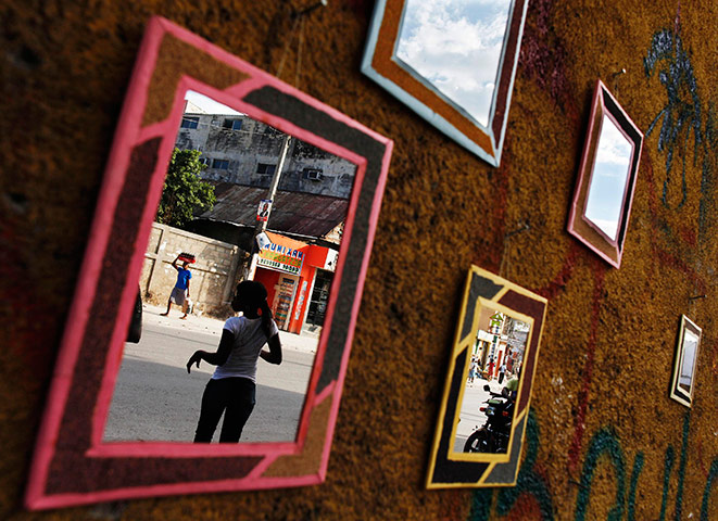 24 hours in pictures: People are reflected in mirrors sold on the streets of Port-au-Prince