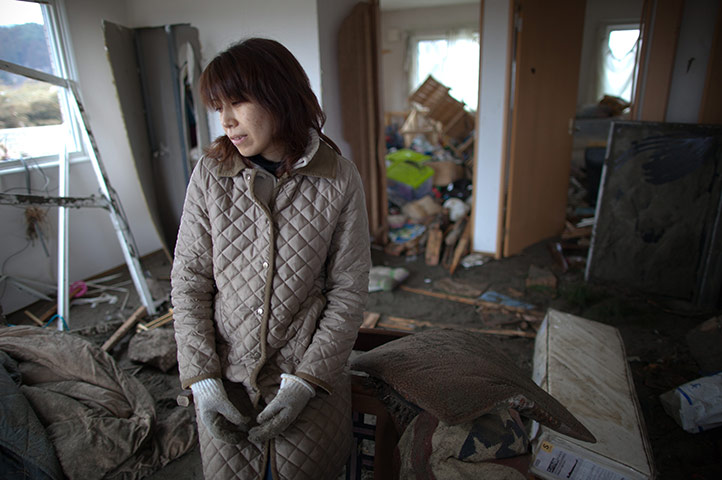 Japan salvage: Aki Kikawada stands in her apartment destroyed by the tsunami 