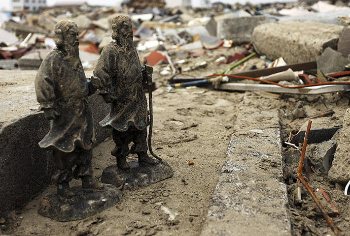 Japan salvage: The remains of a tombstone in a cemetery in Natori