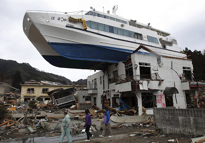 Japan salvage: A boat sits on top of a building in Otsuchi