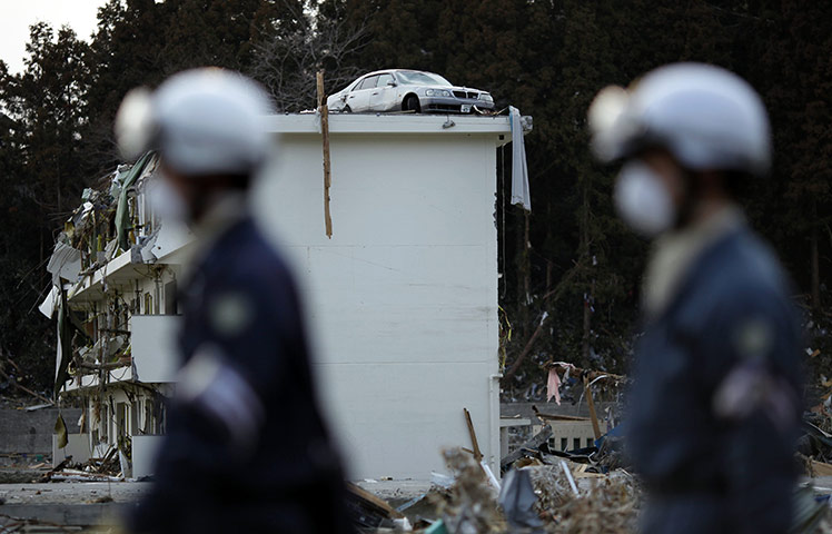 Japan salvage: A car on top of a destroyed building in Minamisanriku