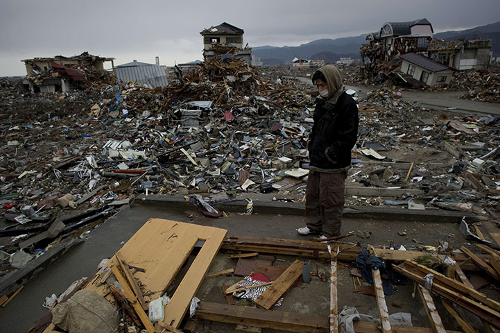 Japan salvage: A resident looks at his destroyed house in Rikuzentakata