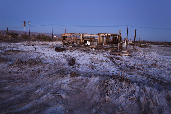 FTA: Jim Lo Scalzo  : An abandoned building sits in a salt pan near Bombay Beach, California
