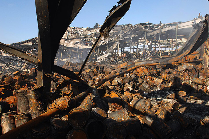 Libya chaos: Libyans inspect damage to sheds after missile strikes in Tripoli