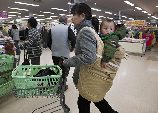 Japan survivors: People enter a supermarket to buy food items in Ichinoseki, Japan